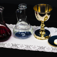 Images of Cruets, chalice, paten and host with white cloth